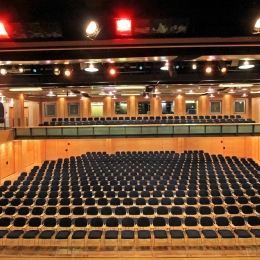 Several rows of chairs are arranged in the lower and on the balcony area.